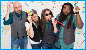 A group of men posing in front of confetti.