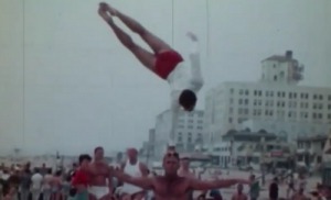 A man on a handstand as part of a baseball game