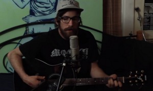 A bearded man playing live acoustic music videos